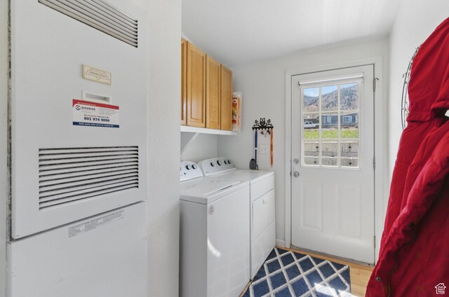 22 E Main St S, Eureka, UT 84628 - washroom featuring separate washer and dryer, cabinet space, and a heating unit