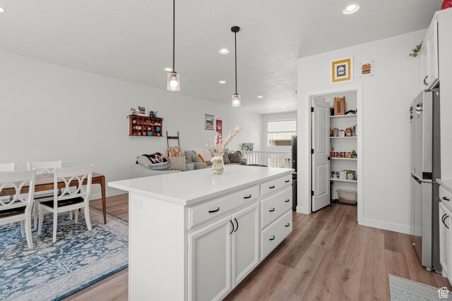 15129 S Halter Way, Bluffdale, UT 84065 - kitchen with light wood-style floors, freestanding refrigerator, recessed lighting, light countertops, and white cabinetry