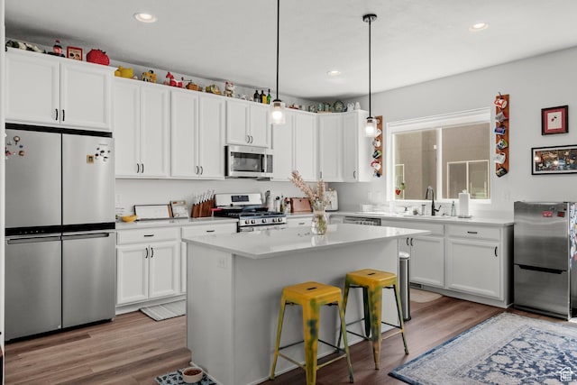 15129 S Halter Way, Bluffdale, UT 84065 - kitchen with stainless steel appliances, white cabinetry, light countertops, light wood finished floors, and recessed lighting