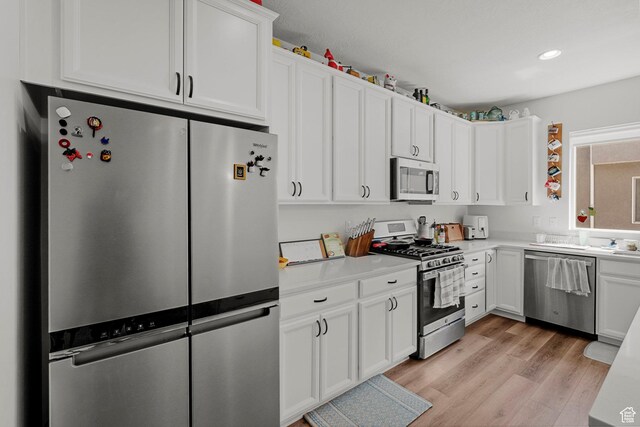 15129 S Halter Way, Bluffdale, UT 84065 - kitchen featuring appliances with stainless steel finishes, light countertops, white cabinetry, and recessed lighting