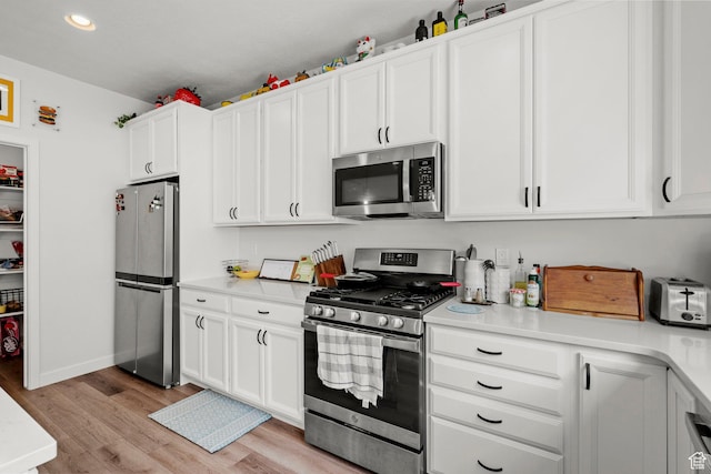 15129 S Halter Way, Bluffdale, UT 84065 - kitchen featuring appliances with stainless steel finishes, light wood-style flooring, light countertops, white cabinets, and recessed lighting