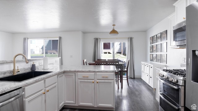 15113 S Bright Stars Dr, Bluffdale, UT 84065 - kitchen featuring stainless steel appliances, healthy amount of natural light, dark wood-style flooring, and white cabinets