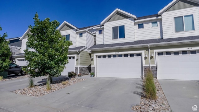 15113 S Bright Stars Dr, Bluffdale, UT 84065 - townhome / multi-family property with stone siding, concrete driveway, and an attached garage