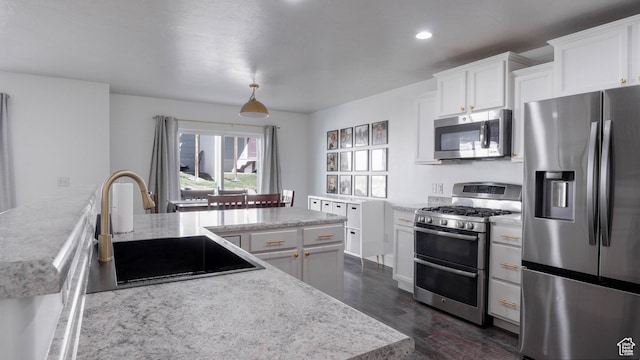 15113 S Bright Stars Dr, Bluffdale, UT 84065 - kitchen featuring appliances with stainless steel finishes, dark wood-style floors, white cabinets, recessed lighting, and a peninsula