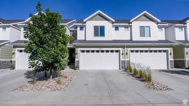 15113 S Bright Stars Dr, Bluffdale, UT 84065 - view of property featuring stone siding, an attached garage, and concrete driveway