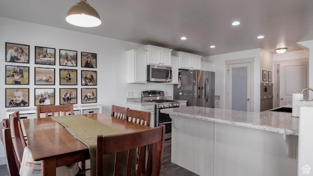 15113 S Bright Stars Dr, Bluffdale, UT 84065 - kitchen featuring stainless steel appliances, white cabinetry, recessed lighting, and light stone countertops