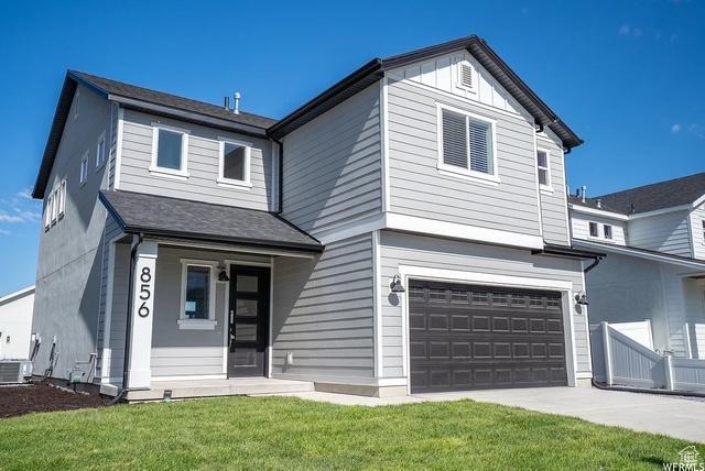 856 S 250 W, American Fork, UT 84003 - traditional-style house with an attached garage, a front yard, and concrete driveway