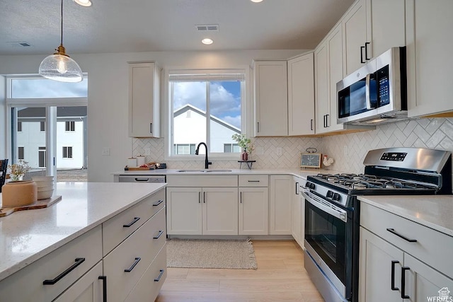 856 S 250 W, American Fork, UT 84003 - kitchen featuring stainless steel appliances, light wood-style flooring, decorative light fixtures, decorative backsplash, and recessed lighting