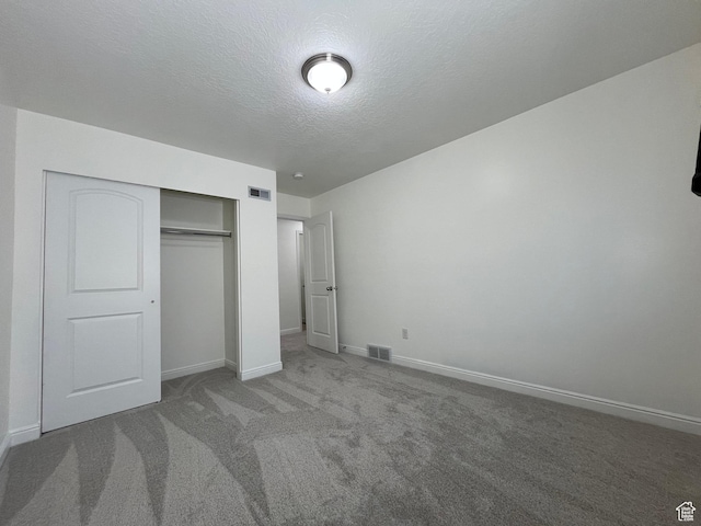 5558 W Dornton Ct, Herriman, UT 84096 - unfurnished bedroom featuring carpet flooring, a textured ceiling, and a closet