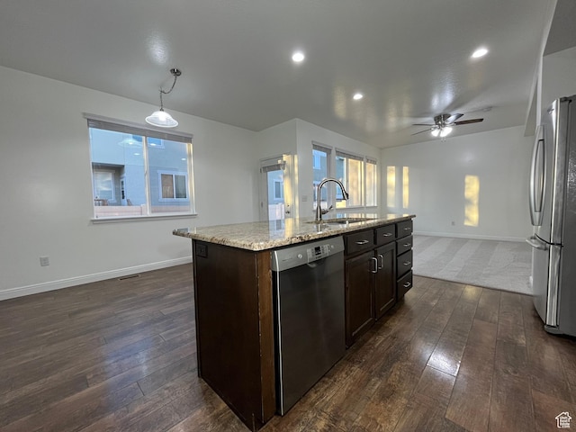 5558 W Dornton Ct, Herriman, UT 84096 - kitchen featuring stainless steel appliances, dark wood-style floors, dark brown cabinetry, light stone counters, and an island with sink