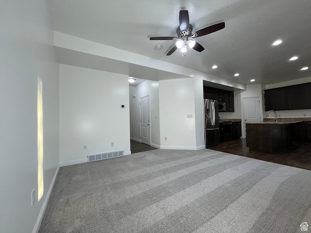 5558 W Dornton Ct, Herriman, UT 84096 - unfurnished living room featuring recessed lighting, dark carpet, and a ceiling fan