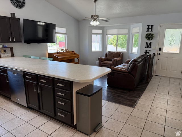 4139 N Mountain View Dr E, Eagle Mountain, UT 84005 - kitchen featuring stainless steel dishwasher, light tile patterned floors, light countertops, a peninsula, and vaulted ceiling