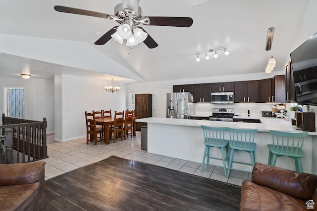 4139 N Mountain View Dr E, Eagle Mountain, UT 84005 - kitchen featuring stainless steel appliances, open floor plan, vaulted ceiling, and light countertops