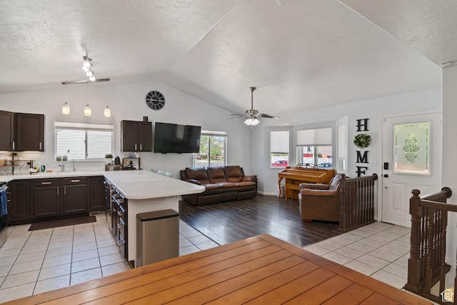 4139 N Mountain View Dr E, Eagle Mountain, UT 84005 - kitchen with light countertops, vaulted ceiling, open floor plan, light tile patterned floors, and ceiling fan