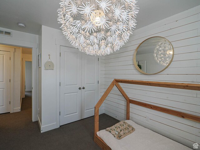 1051 W Narrows Ln S, Bluffdale, UT 84065 - bedroom featuring wood walls, a closet, a chandelier, and dark carpet