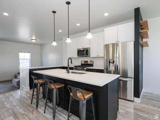 1051 W Narrows Ln S, Bluffdale, UT 84065 - kitchen featuring stainless steel appliances, light wood-style floors, a breakfast bar, light countertops, and recessed lighting