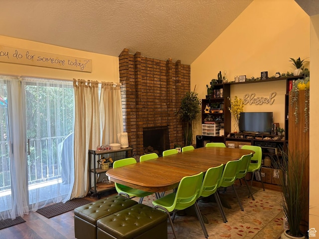 8158 S Cottonwood Hills Cir, Sandy, UT 84094 - dining space with lofted ceiling, a fireplace, wood finished floors, and a textured ceiling