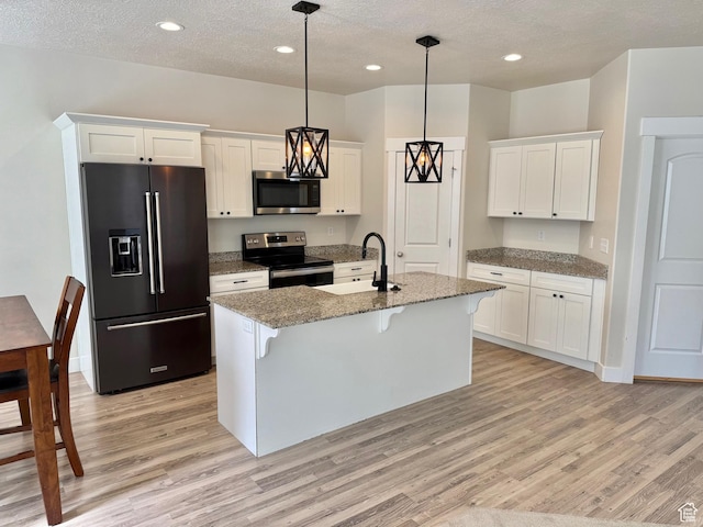 1611 N 3860 W, Lehi, UT 84043 - kitchen with high end refrigerator, electric range oven, stainless steel microwave, light wood finished floors, and a breakfast bar