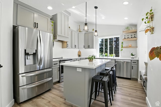 2265 Casperville Rd, Heber City, UT 84032 - kitchen with stainless steel appliances, open shelves, light countertops, vaulted ceiling, and light wood-style flooring