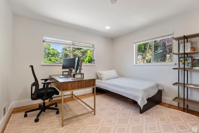 2922 E Hillsden Dr, Holladay, UT 84117 - bedroom with multiple windows, wood finished floors, a desk, and recessed lighting