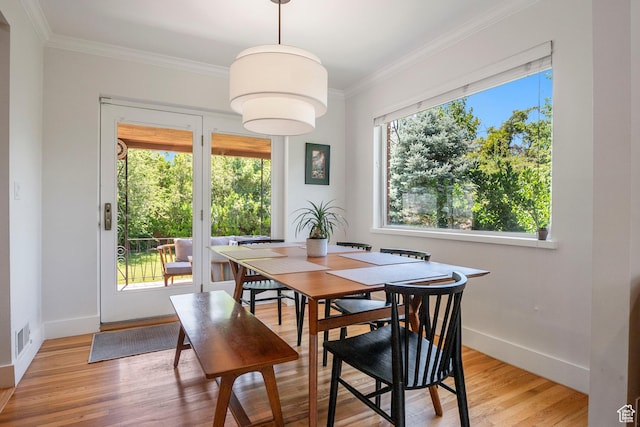 2922 E Hillsden Dr, Holladay, UT 84117 - dining space with healthy amount of natural light, crown molding, and light wood-style floors
