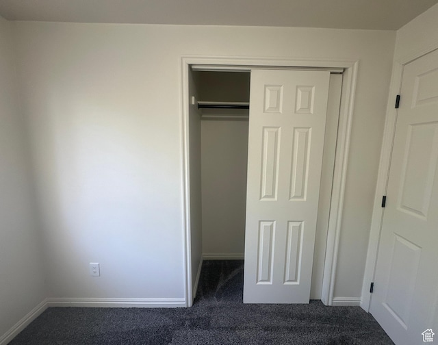 469 Canfield Dr, Ogden, UT 84404 - unfurnished bedroom featuring dark colored carpet and a closet