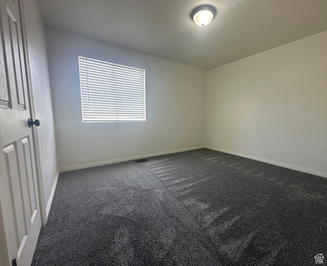 469 Canfield Dr, Ogden, UT 84404 - empty room with dark colored carpet and baseboards