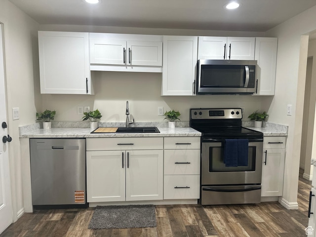 469 Canfield Dr, Ogden, UT 84404 - kitchen featuring stainless steel appliances, recessed lighting, dark wood-style flooring, white cabinets, and light stone counters