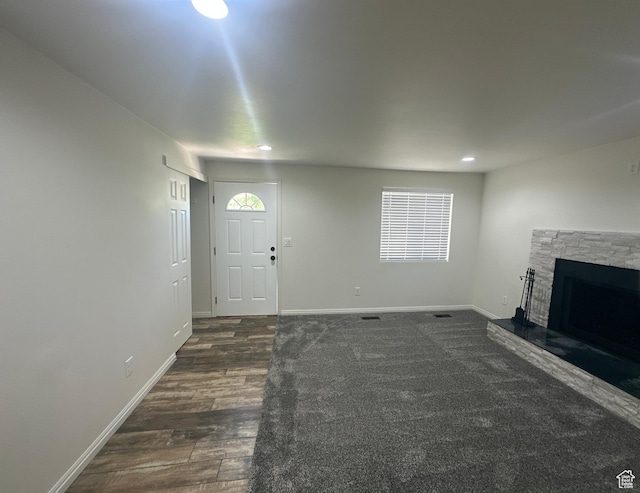 469 Canfield Dr, Ogden, UT 84404 - unfurnished living room with a stone fireplace, dark wood-style floors, and recessed lighting