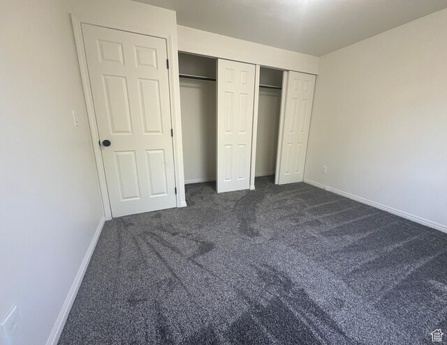 469 Canfield Dr, Ogden, UT 84404 - unfurnished bedroom featuring dark colored carpet and a closet