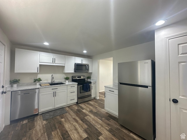 469 Canfield Dr, Ogden, UT 84404 - kitchen featuring stainless steel appliances, dark wood finished floors, recessed lighting, white cabinets, and light stone countertops