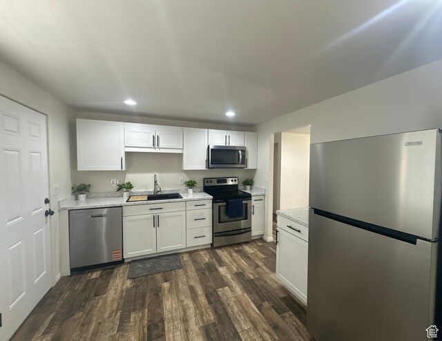 469 Canfield Dr, Ogden, UT 84404 - kitchen featuring stainless steel appliances, recessed lighting, dark wood-style flooring, white cabinetry, and light stone counters