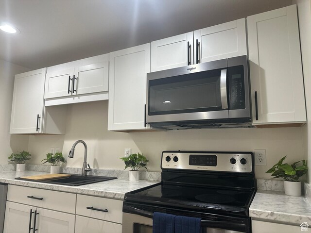 469 Canfield Dr, Ogden, UT 84404 - kitchen with appliances with stainless steel finishes, white cabinetry, and recessed lighting