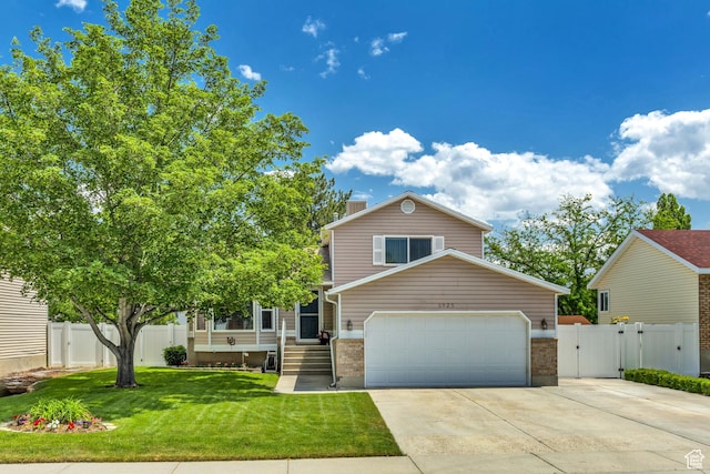 6925 S Sparrowtail Rd W, West Jordan, UT 84081 - view of front of house with a gate, driveway, an attached garage, and a chimney