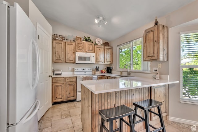 6925 S Sparrowtail Rd W, West Jordan, UT 84081 - kitchen featuring white appliances, a peninsula, healthy amount of natural light, and lofted ceiling