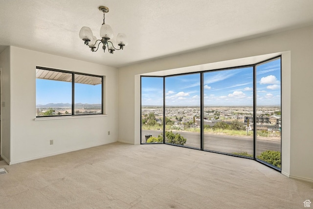 42 S Juniper Dr, Cedar City, UT 84720 - empty room with a chandelier, carpet, and healthy amount of natural light