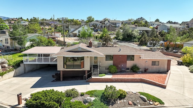 42 S Juniper Dr, Cedar City, UT 84720 - back of house with a residential view, driveway, stucco siding, and roof with shingles