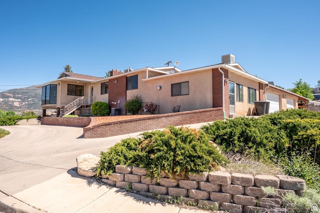 42 S Juniper Dr, Cedar City, UT 84720 - single story home featuring a garage, brick siding, driveway, a chimney, and stucco siding