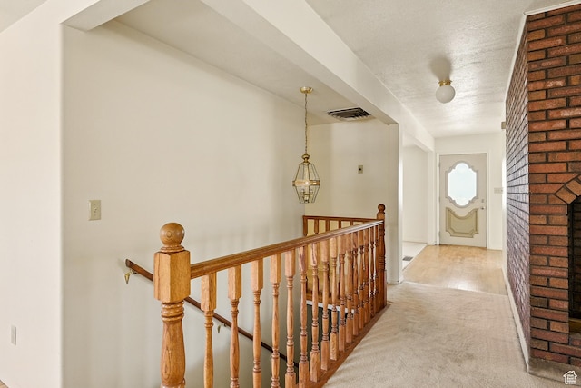 42 S Juniper Dr, Cedar City, UT 84720 - hallway with an upstairs landing, carpet floors, and a textured ceiling