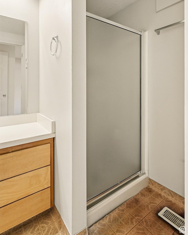 42 S Juniper Dr, Cedar City, UT 84720 - full bathroom featuring a stall shower, vanity, and tile patterned flooring