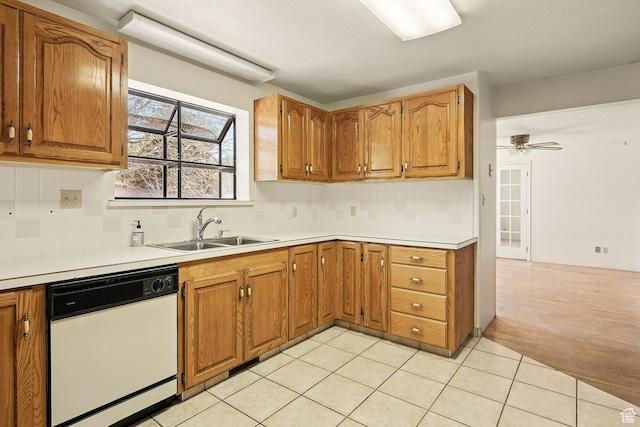 42 S Juniper Dr, Cedar City, UT 84720 - kitchen with white dishwasher, backsplash, brown cabinets, and light countertops