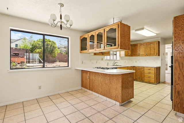 42 S Juniper Dr, Cedar City, UT 84720 - kitchen with a peninsula, healthy amount of natural light, a chandelier, light countertops, and a textured ceiling