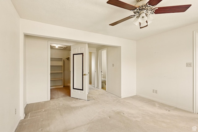 42 S Juniper Dr, Cedar City, UT 84720 - unfurnished bedroom with light colored carpet, a walk in closet, a closet, ceiling fan, and ensuite bath
