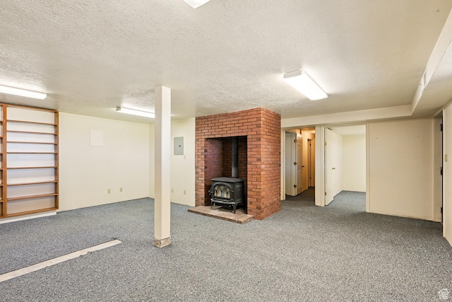 42 S Juniper Dr, Cedar City, UT 84720 - finished below grade area with a wood stove, carpet flooring, a textured ceiling, and electric panel