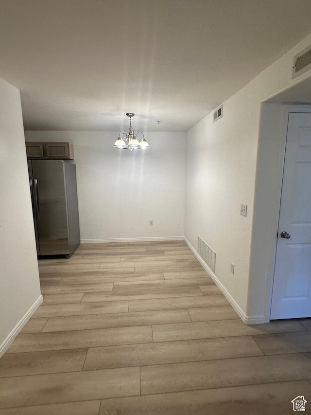 59 W Ridge Rd N, Saratoga Springs, UT 84043 - unfurnished dining area featuring light wood-style flooring and a chandelier