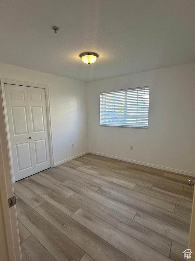 59 W Ridge Rd N, Saratoga Springs, UT 84043 - unfurnished room with light wood-type flooring and fire sprinkler in ceiling