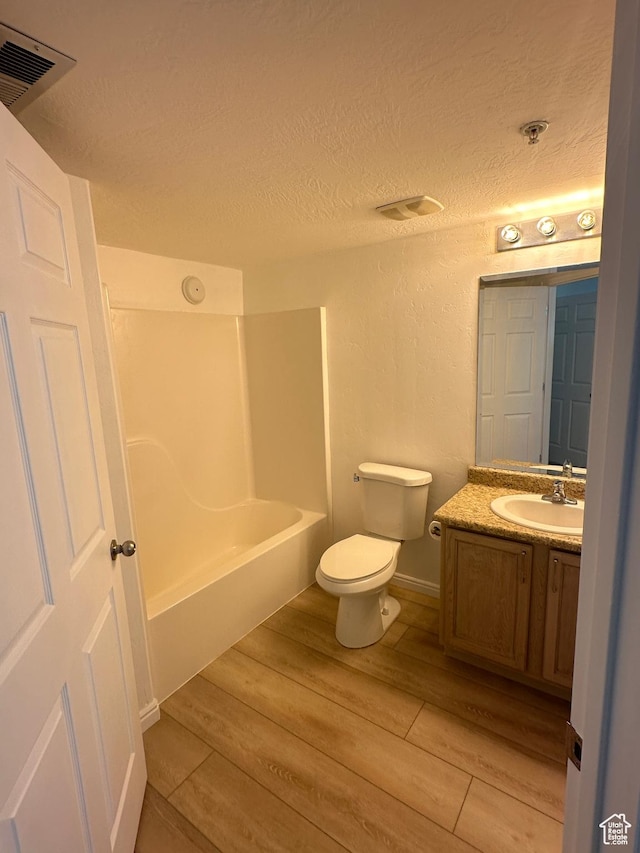 59 W Ridge Rd N, Saratoga Springs, UT 84043 - bathroom featuring vanity, wood finished floors, a textured ceiling, bathtub / shower combination, and a textured wall