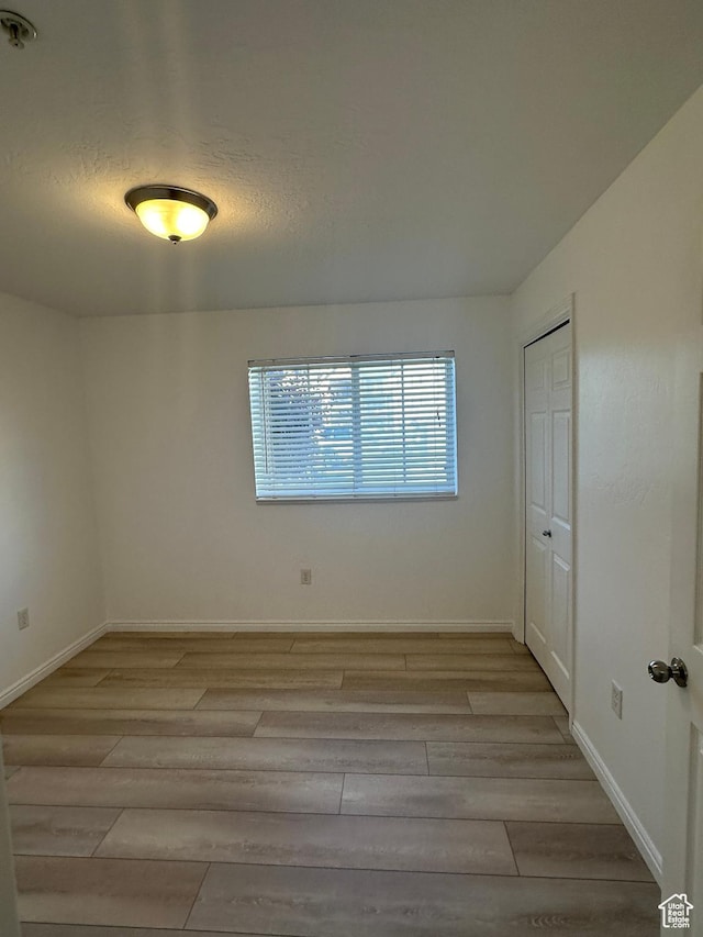 59 W Ridge Rd N, Saratoga Springs, UT 84043 - spare room with light wood finished floors and fire sprinkler in ceiling