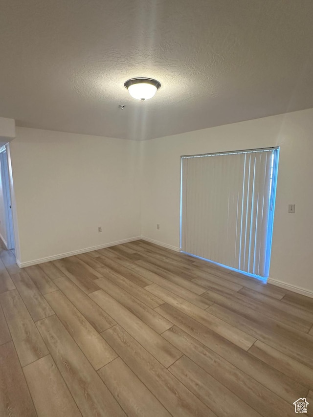 59 W Ridge Rd N, Saratoga Springs, UT 84043 - spare room featuring light wood finished floors and a textured ceiling