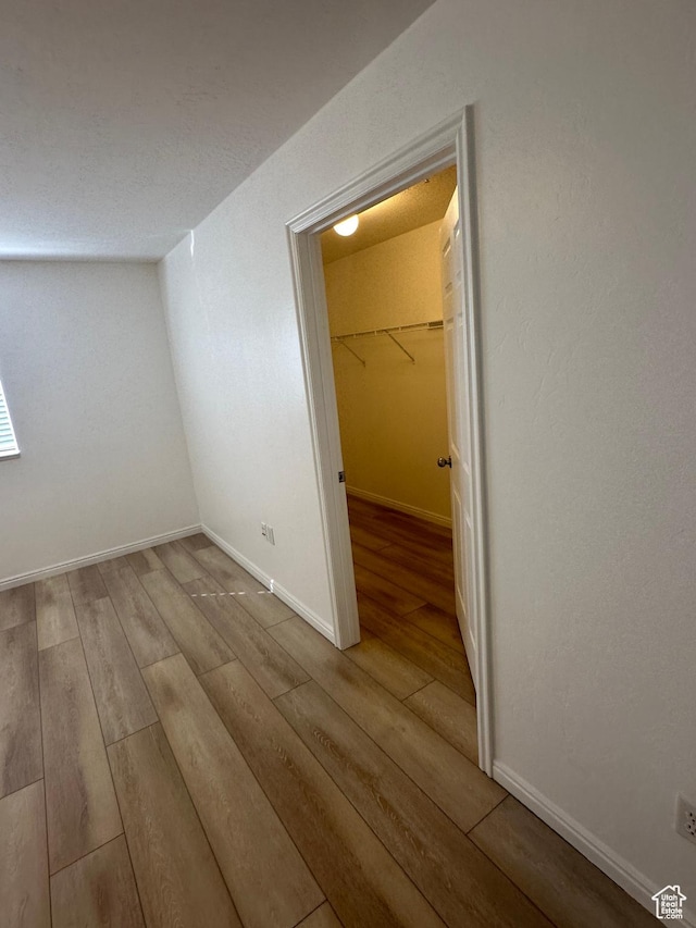 59 W Ridge Rd N, Saratoga Springs, UT 84043 - unfurnished bedroom with wood finished floors, a closet, and a walk in closet